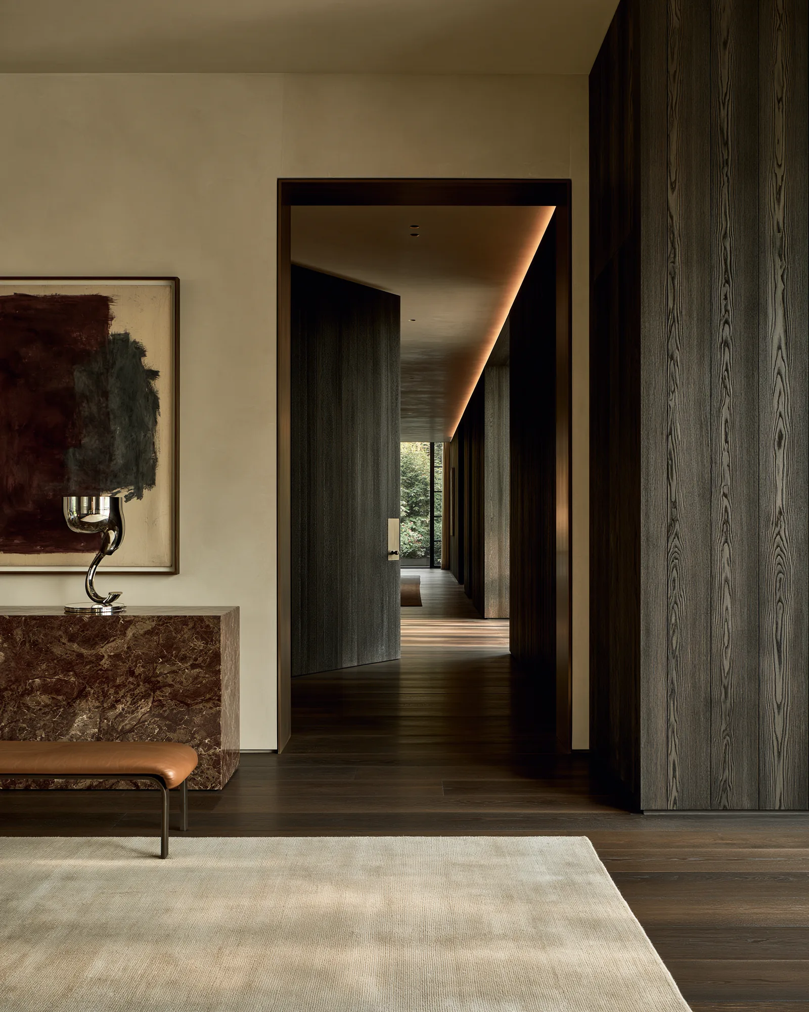 Entrance hall with a marble console, looking through to the garden beyond