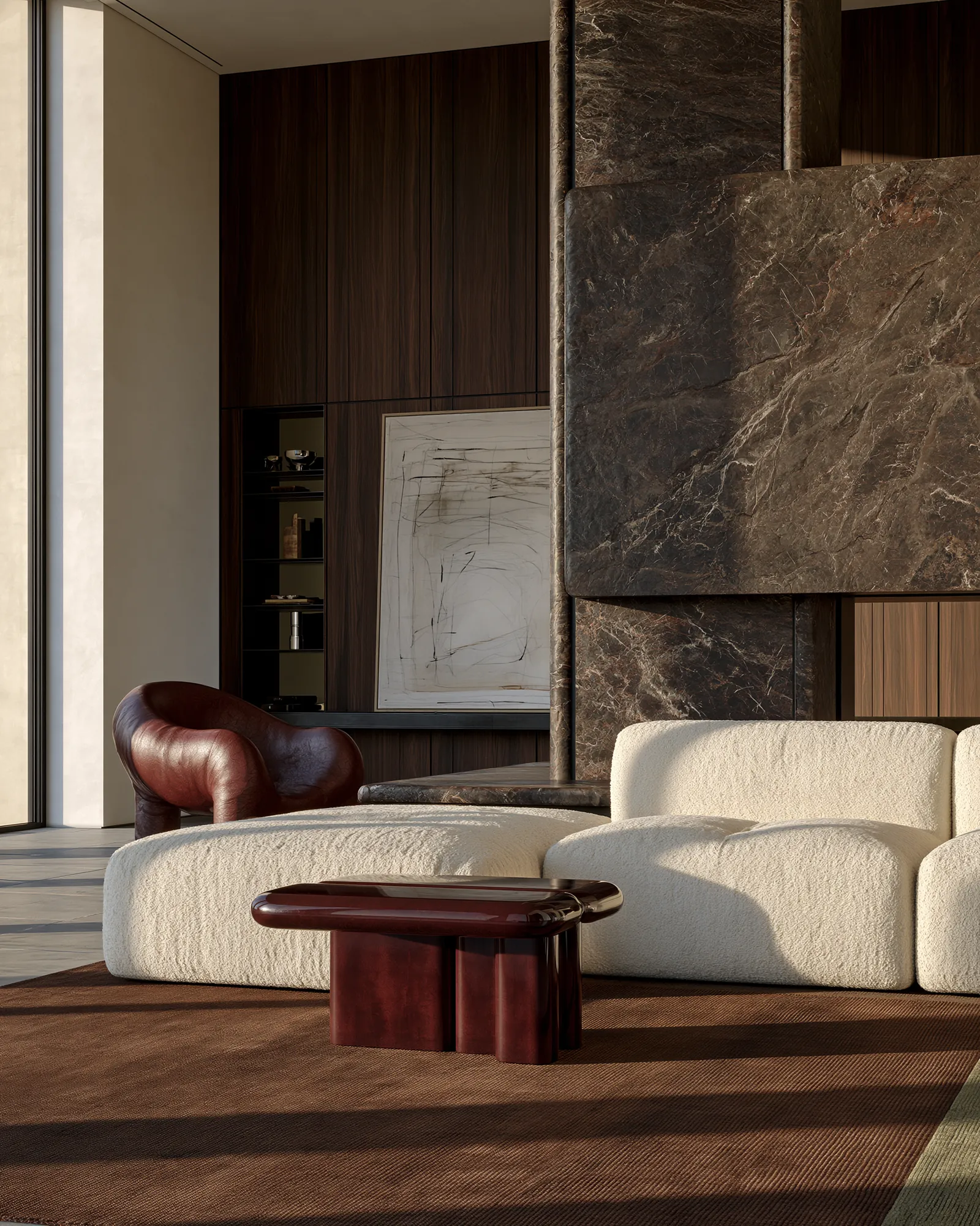 Sitting room with a cream bouclé sofa and an oxblood leather armchair set against a veined brown stone chimney breast and dark timber panelling, with a lacquered burgundy low table on a rust-brown rug